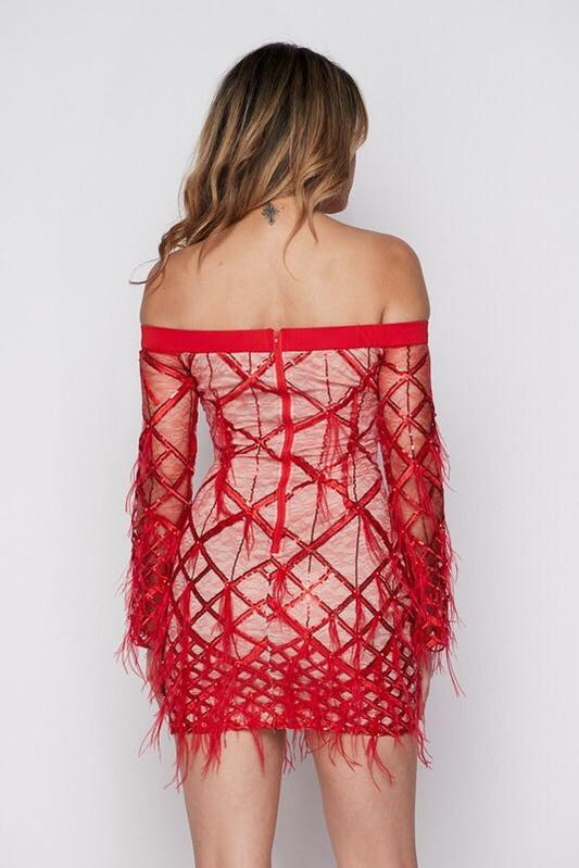 a woman in a red dress holding a purse