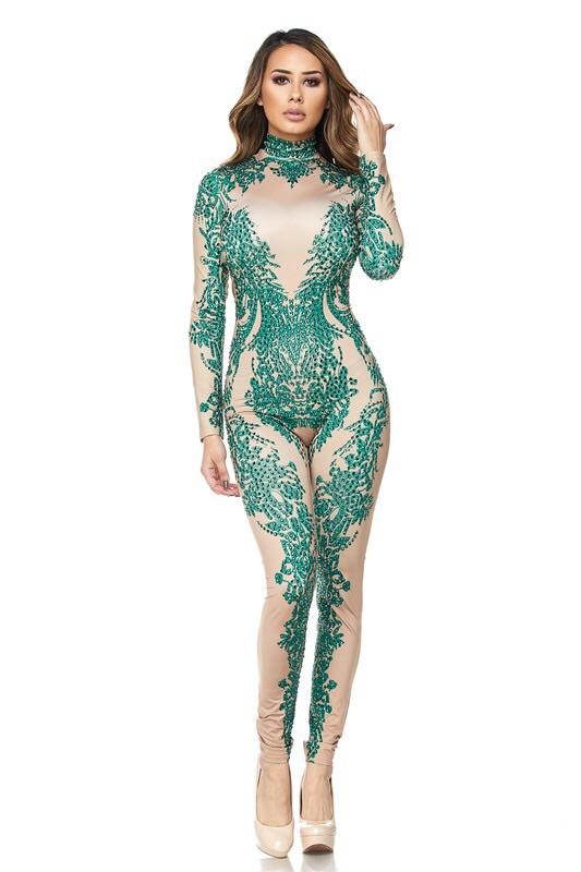 a woman in a green dress is holding a tennis racket