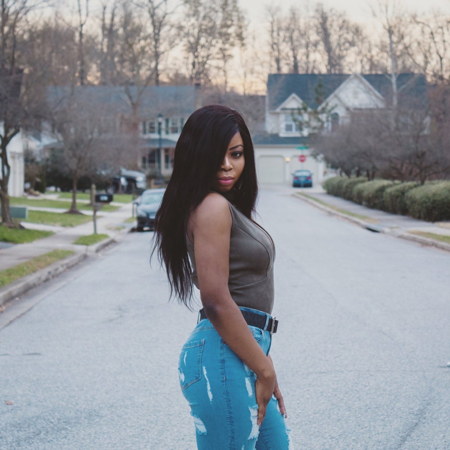 a woman standing on the side of a road