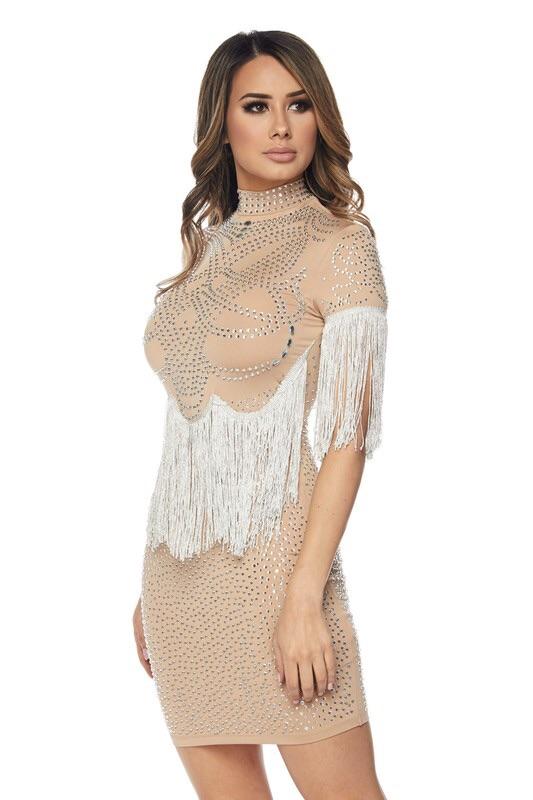 a woman in a dress standing next to a bench