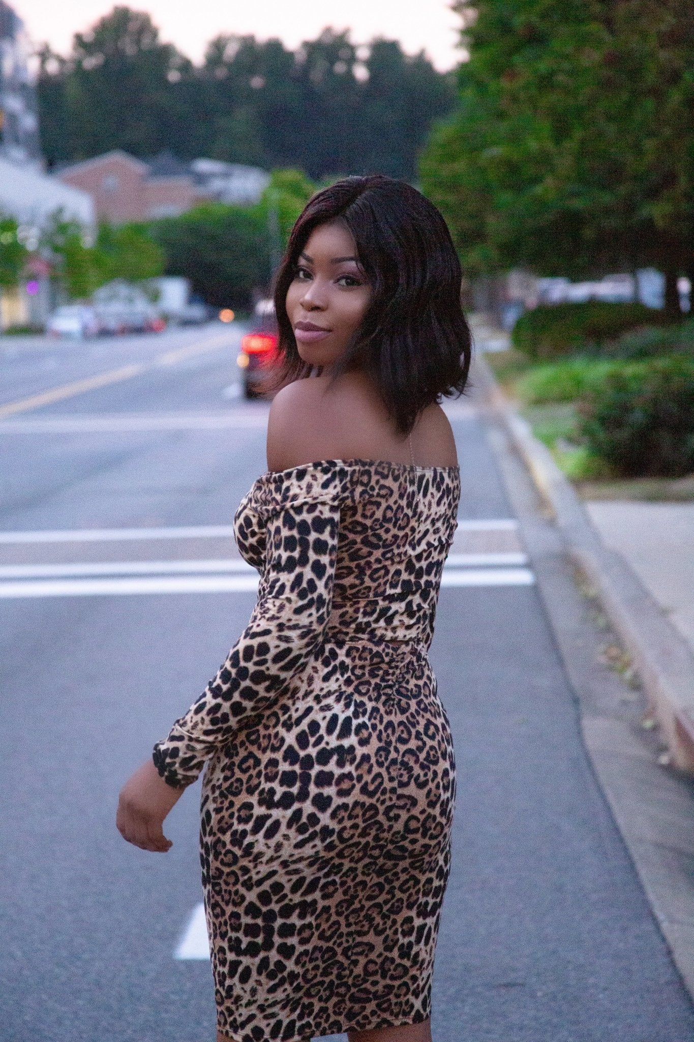 a woman in a dress is holding a cell phone