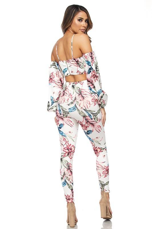 a woman in a pink dress standing on a bench