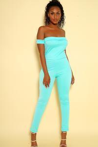 a woman in a blue dress standing on a surfboard