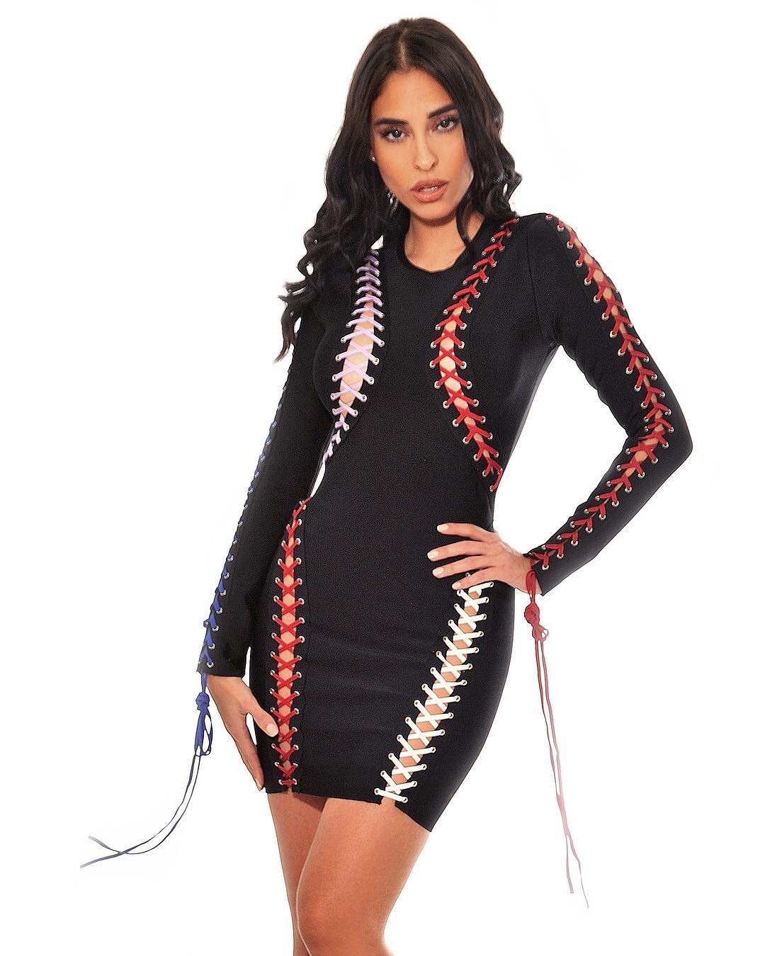 a woman in a black dress holding a tennis racquet