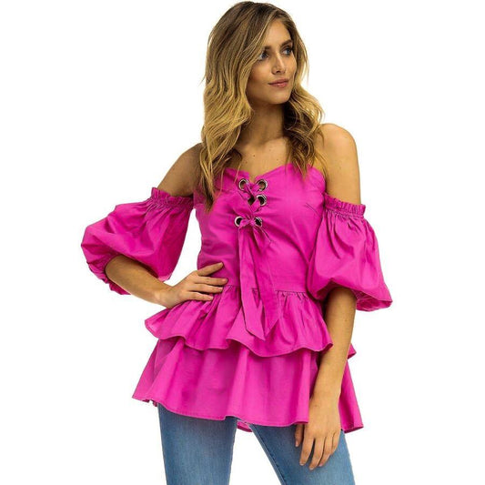 a girl in a pink dress holding a cell phone