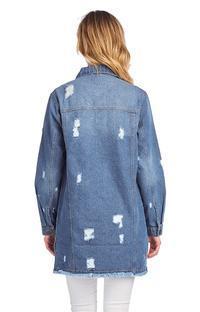 a woman standing in front of a yellow wall