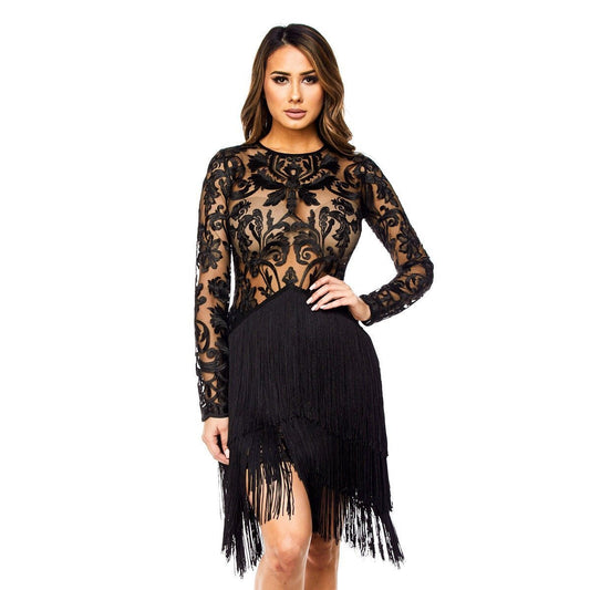 a woman in a black dress sitting on a bench