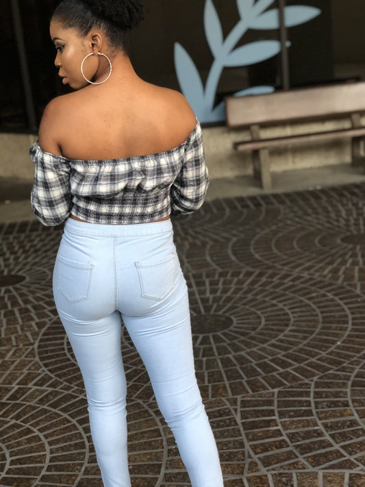 a woman standing on a baseball field holding a bat