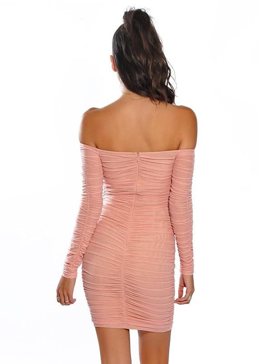 a woman in a pink dress holding a tennis racquet