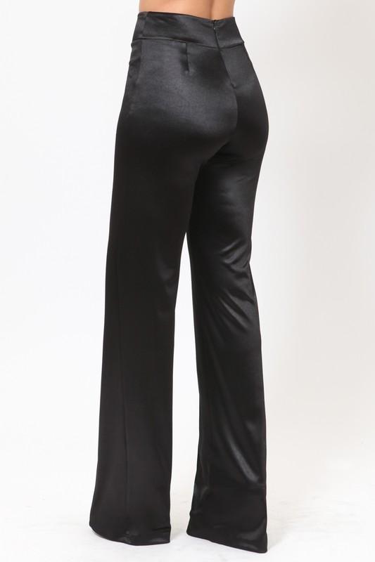 a man wearing a black suit and tie