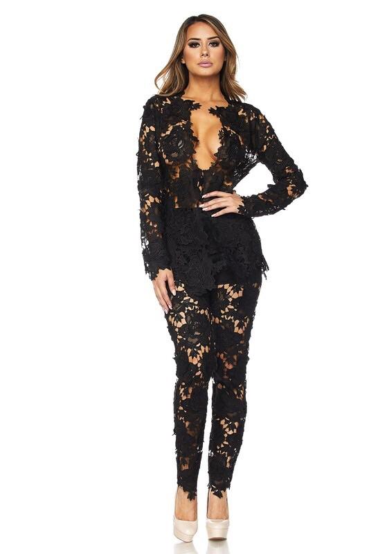 a woman in a black outfit standing on a bench