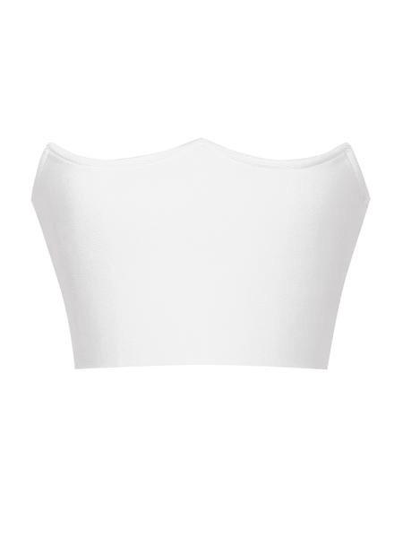 a white couch sitting next to a white wall