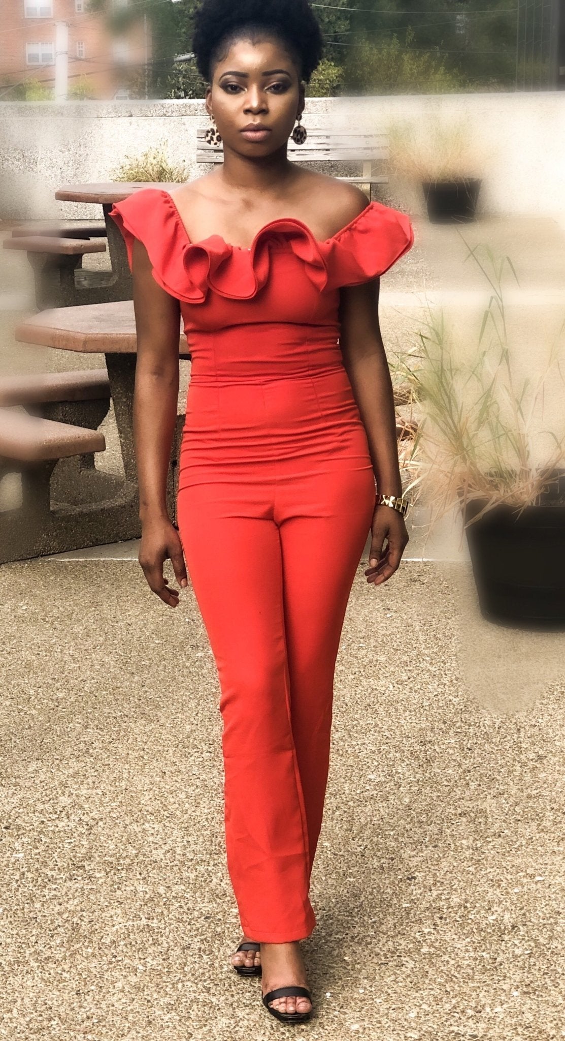 a woman in a red dress walking down the street 